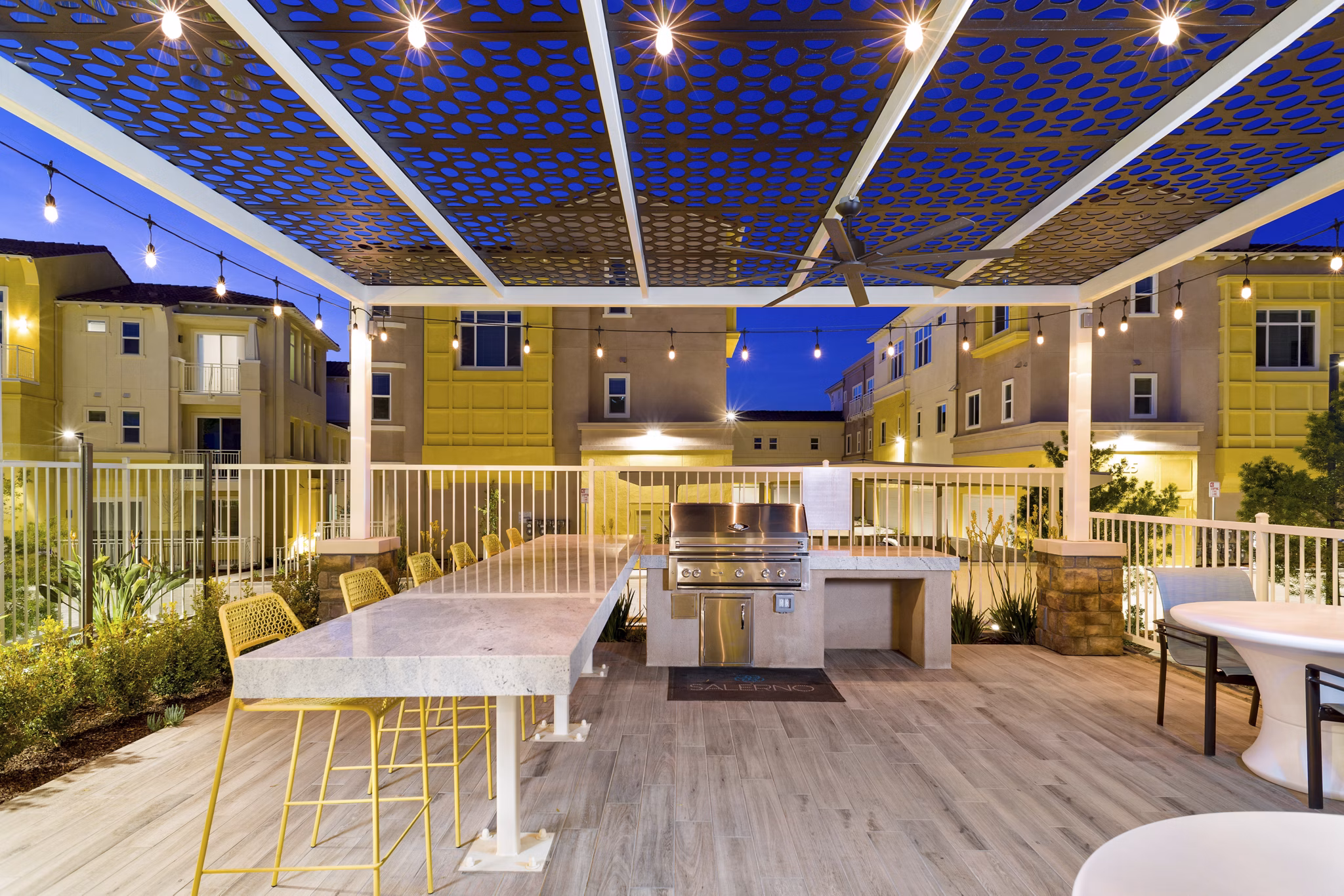 Patio and grill area overlooking landscaped gardens at Salerno Apartments