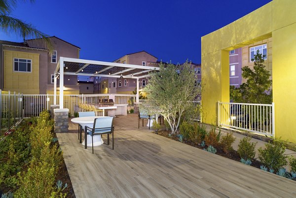 Patio and grill area with stylish seating at Salerno Apartments, a luxury Greystar community