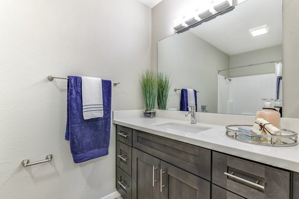 Modern bathroom with sleek fixtures and marble countertops at Santee Villas Apartments