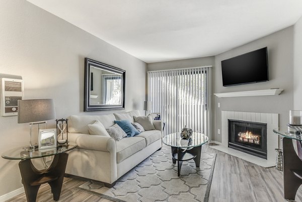 Spacious living room with modern decor and cozy seating at Santee Villas Apartments