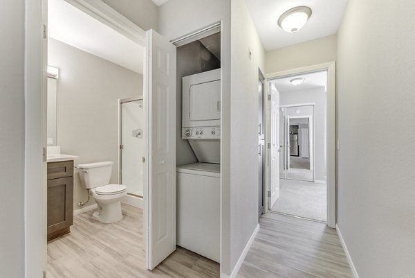 Functional laundry room with modern appliances and clean bathroom at Santee Villas Apartments, offering convenience and style