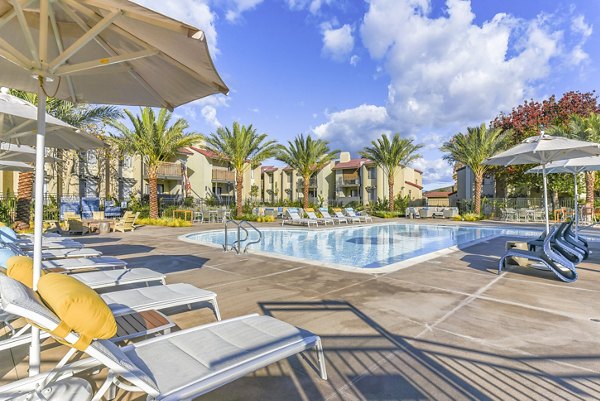 Relaxing pool area with lounge chairs at Santee Villas Apartments, offering luxury living and great amenities in sunny Santee