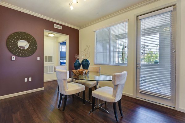 Dining room with elegant lighting and modern furniture at Seta Apartments
