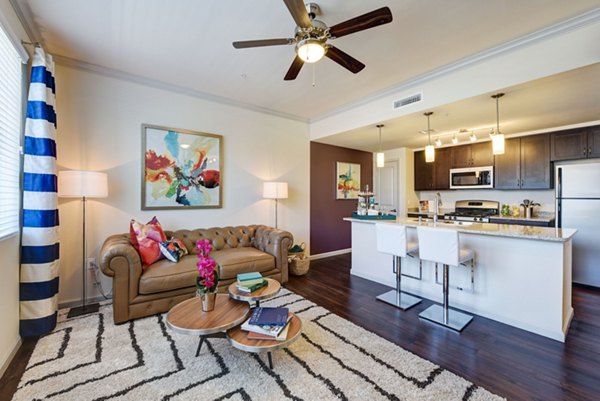 Elegant living room with plush seating and natural light at Seta Apartments, luxury residences by Greystar