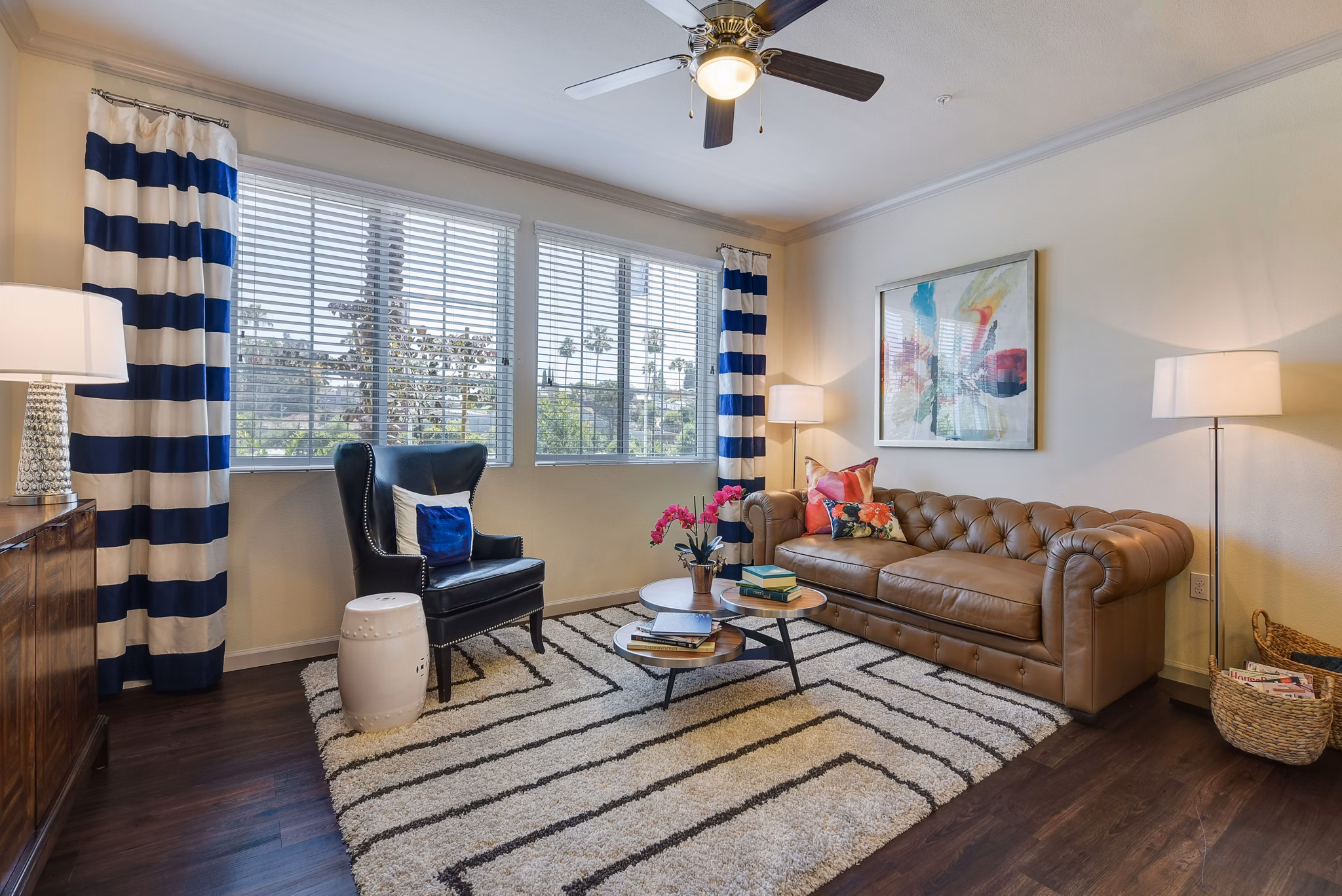 Stylish living room featuring modern decor and large windows at Seta Apartments