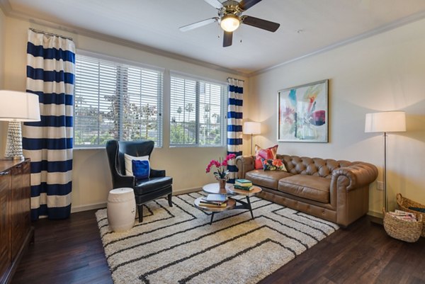 Stylish living room featuring modern decor and large windows at Seta Apartments