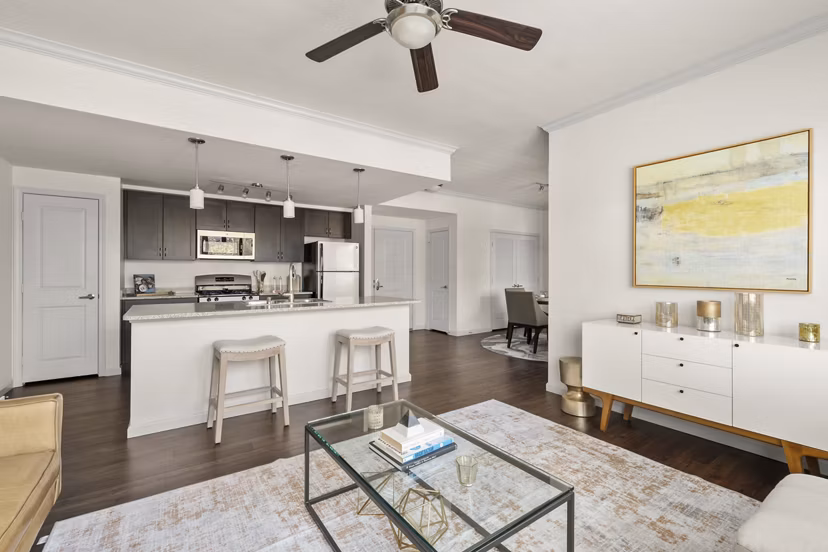 Spacious living room with modern decor and large windows at Seta Apartments, offering luxurious comfort and style in city living
