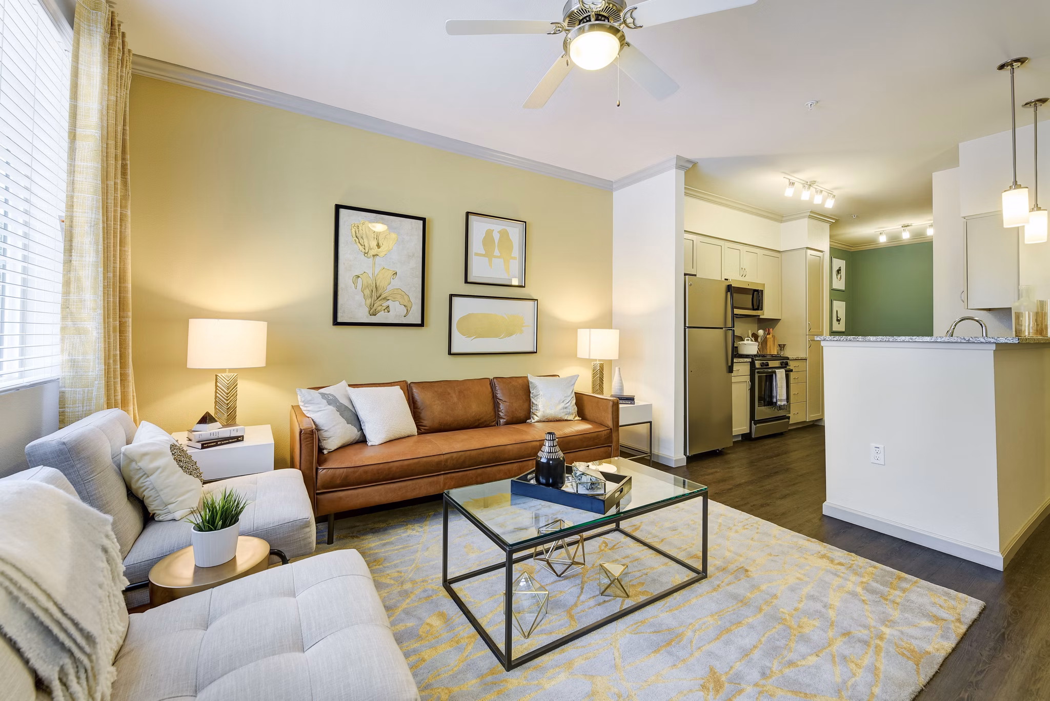 Spacious living room with modern decor and large windows at Seta Apartments, offering luxurious comfort and style in city living
