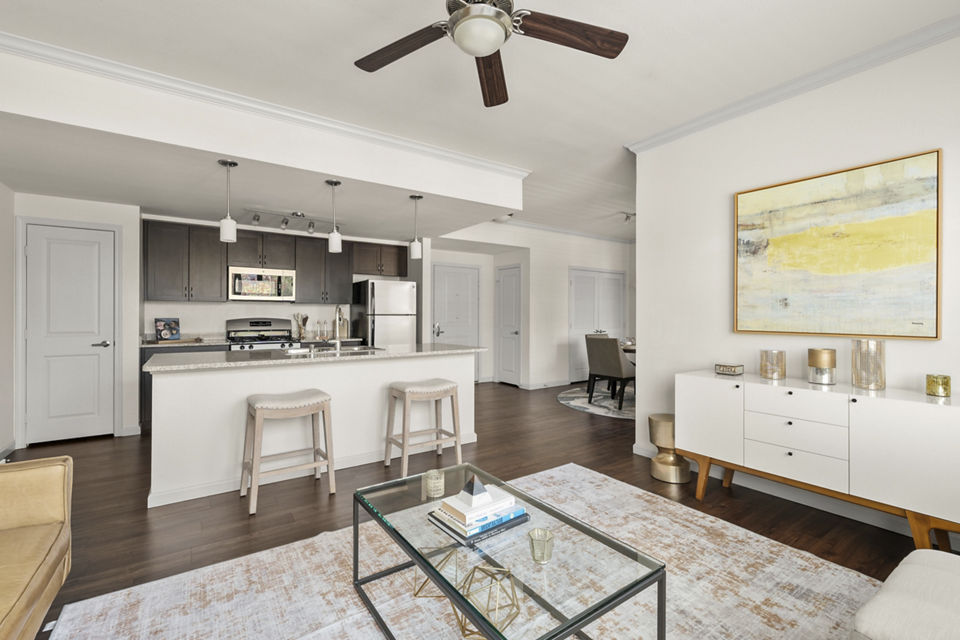 Spacious living room with modern decor and large windows at Seta Apartments, offering luxurious comfort and style in city living