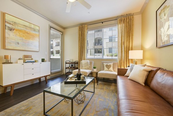 Cozy living room with contemporary dÃ©cor and large windows at Seta Apartments, Greystar luxury apartments in vibrant urban setting
