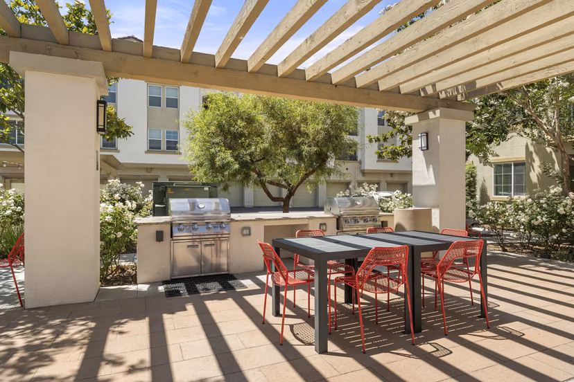 Seta Apartments: Modern patio with stylish seating and greenery in luxury Greystar community