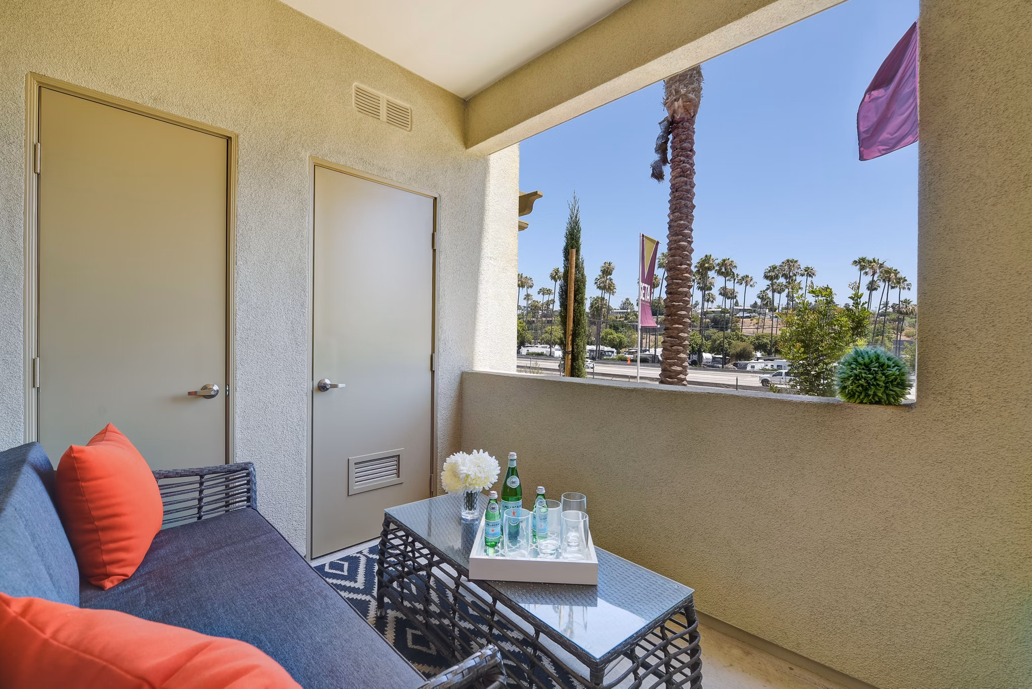 Seta Apartments: Modern patio with stylish seating and greenery in luxury Greystar community