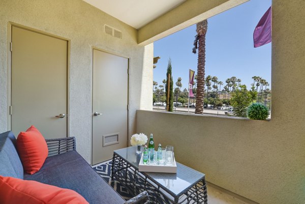 Seta Apartments: Modern patio with stylish seating and greenery in luxury Greystar community