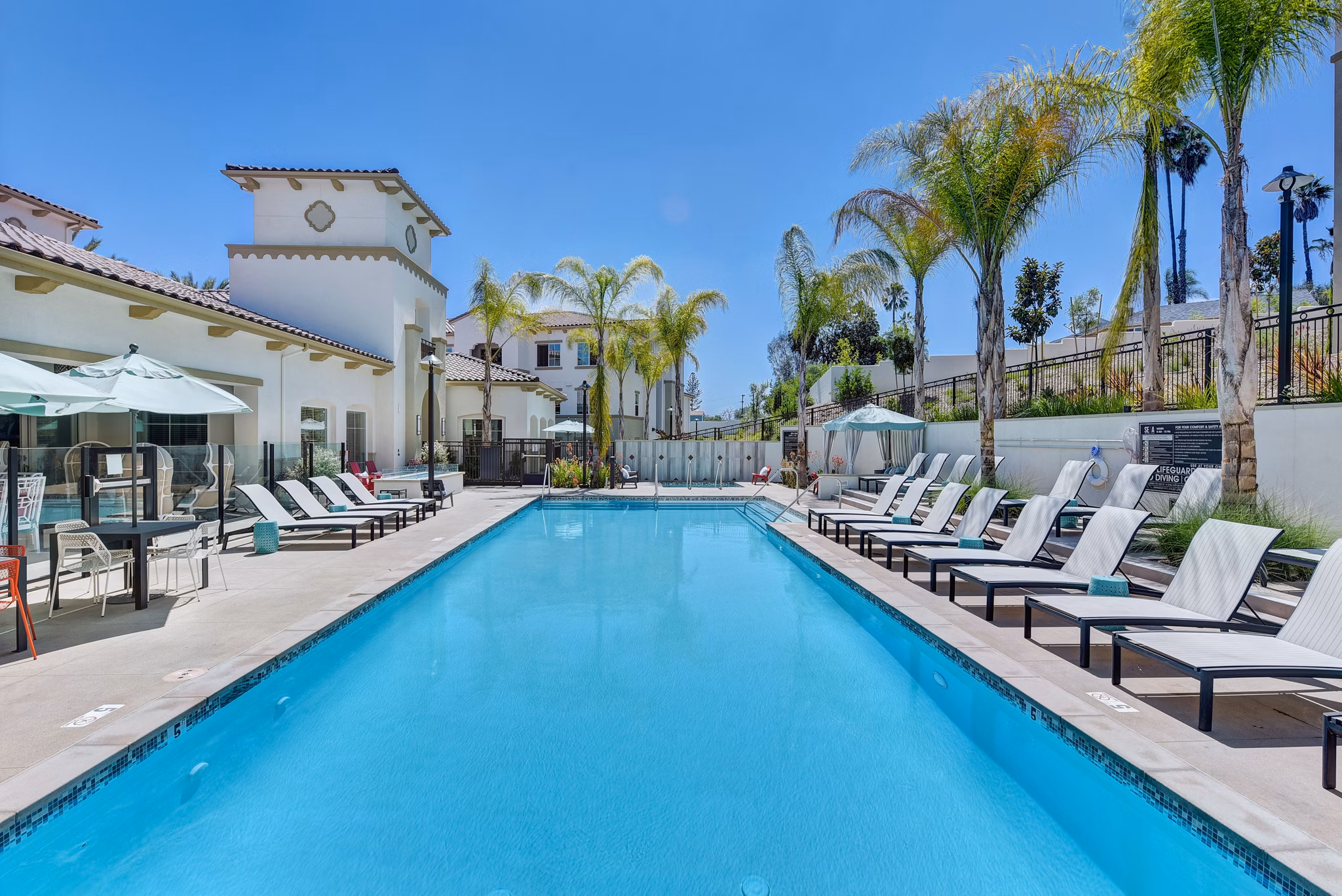 Resort-style pool area with lounge chairs at Seta Apartments, luxury living in an urban setting
