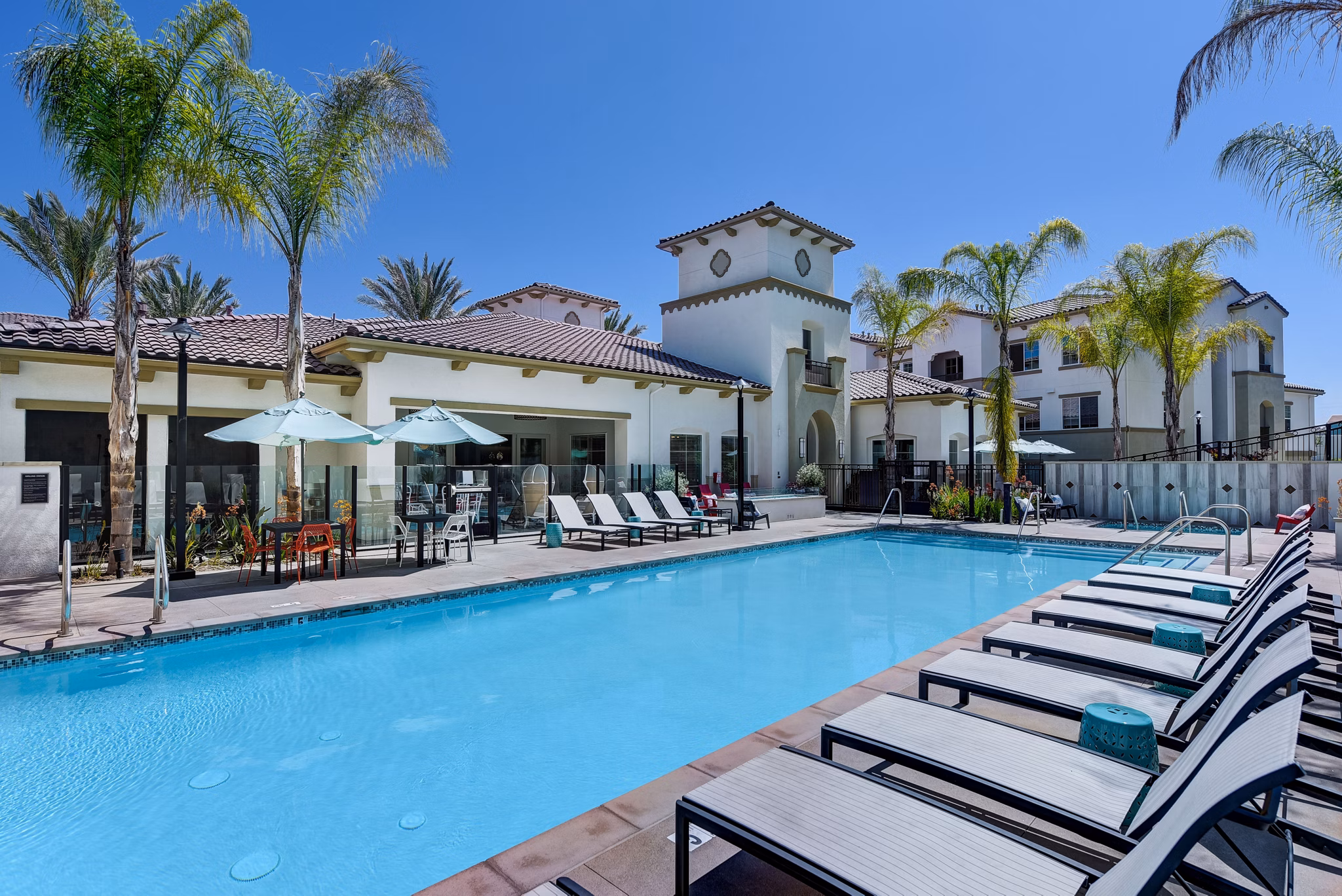 Resort-style pool area with lounge chairs at Seta Apartments, a Greystar luxury community