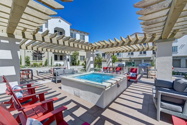 Luxurious pool area with lounge chairs at Seta Apartments, a Greystar luxury community in an urban setting