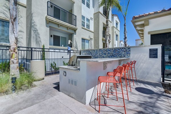 Outdoor grill area at Seta Apartments featuring modern BBQ stations and seating