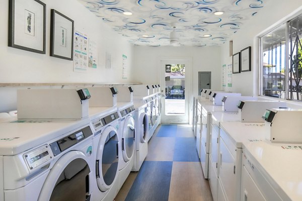 Laundry facility featuring modern equipment at Softwind Point Apartments