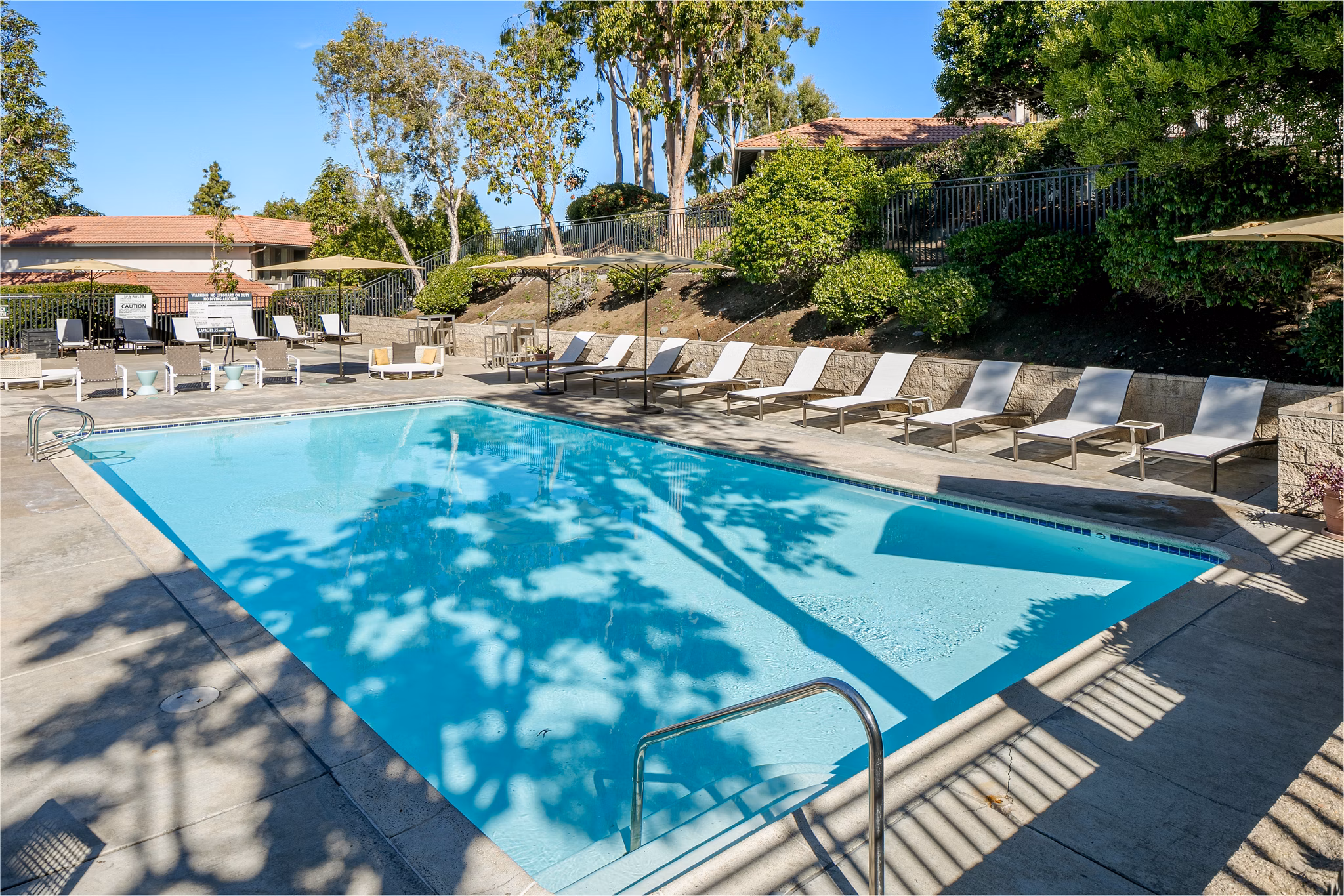 Resort-style pool with loungers at Softwind Point Apartments offering luxury living near scenic views