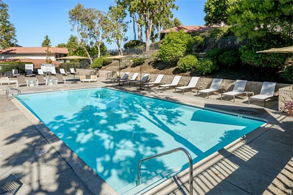 Resort-style pool with loungers at Softwind Point Apartments offering luxury living near scenic views