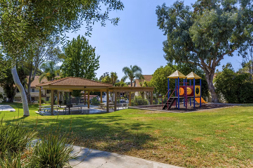 Modern playground with slides and swings at Softwind Point Apartments for family-friendly fun