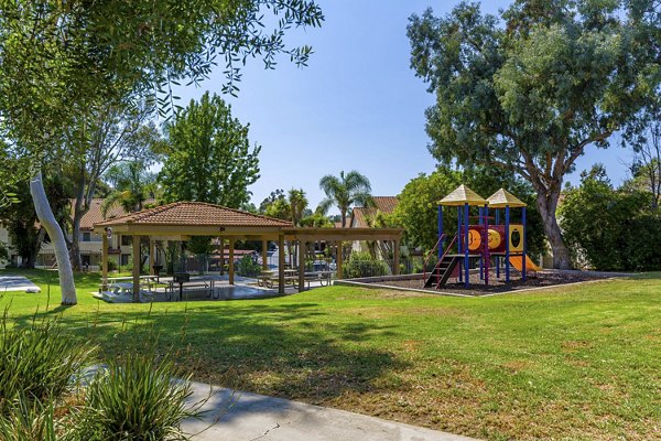 Modern playground with slides and swings at Softwind Point Apartments for family-friendly fun