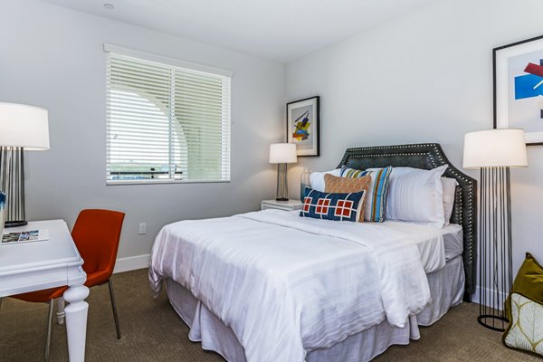 Cozy bedroom with stylish decor at Sola at Pacific Highlands Ranch Apartments