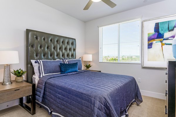 Cozy bedroom with modern decor at Sola at Pacific Highlands Ranch Apartments