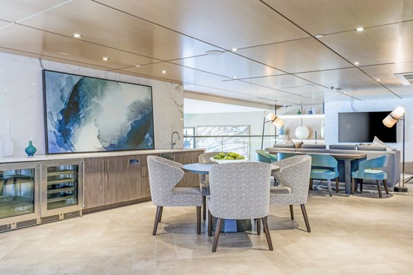 Sola at Pacific Highlands Ranch Apartments: Contemporary clubhouse with stylish seating and large windows in San Diego