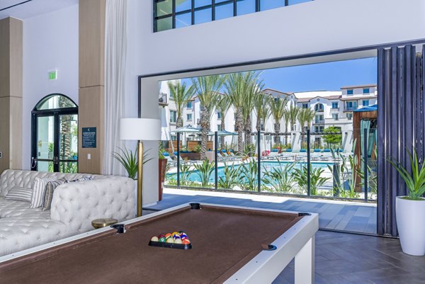 Sola at Pacific Highlands Ranch: Clubhouse game room featuring modern seating and gaming tables at luxury apartments