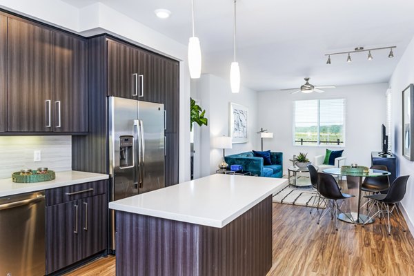 Kitchen with modern appliances and quartz countertops at Sola at Pacific Highlands Ranch Apartments