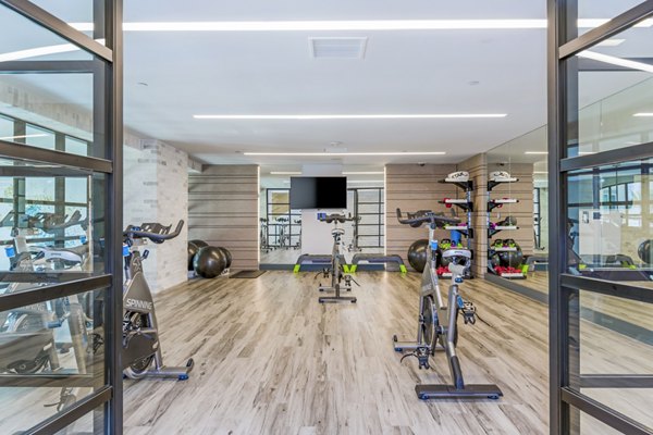 Spin studio with state-of-the-art bikes and mirrors at Sola at Pacific Highlands Ranch Apartments Perfect for fitness enthusiasts seeking luxury living