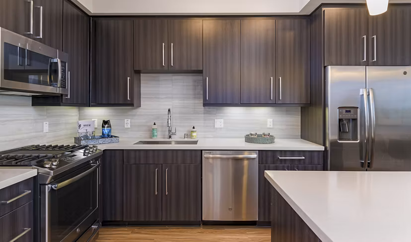 Modern kitchen with stainless steel appliances at Sola at Pacific Highlands Ranch Apartments, a luxury community by Greystar