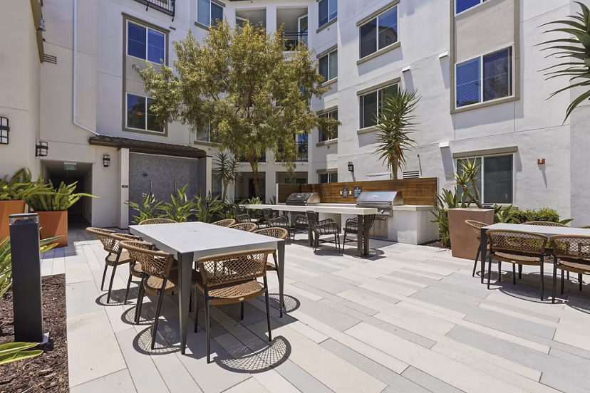 Patio cabanas with comfortable seating at Sola at Pacific Highlands Ranch Apartments