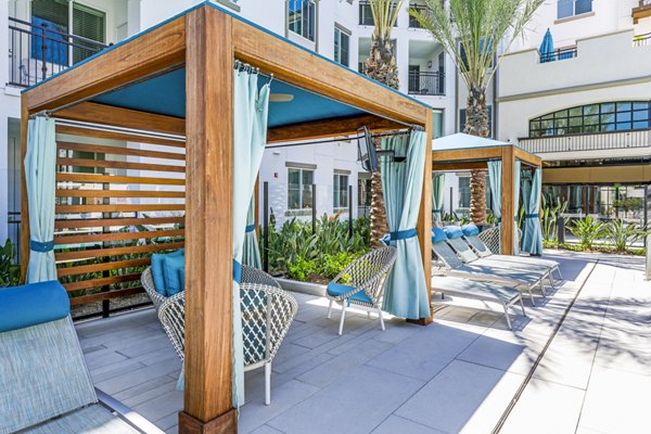 Patio cabanas with comfortable seating at Sola at Pacific Highlands Ranch Apartments
