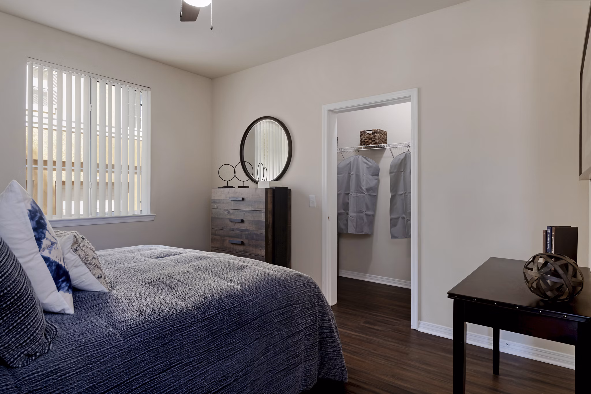 Cozy bedroom with large windows at Missions at Sunbow Apartments offering luxury living in a serene setting