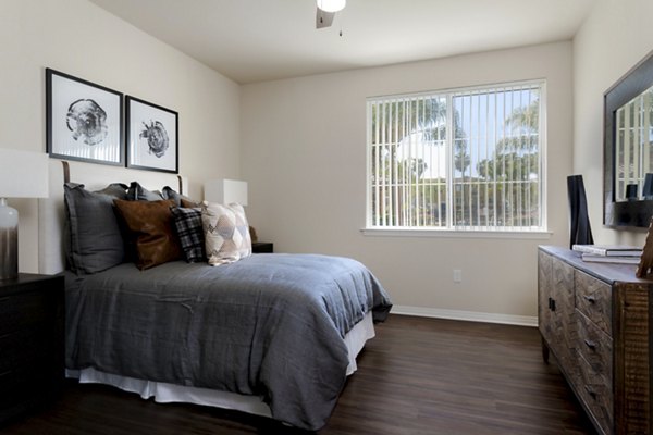 Cozy bedroom with modern decor at Missions at Sunbow Apartments Perfect for luxury living and comfort