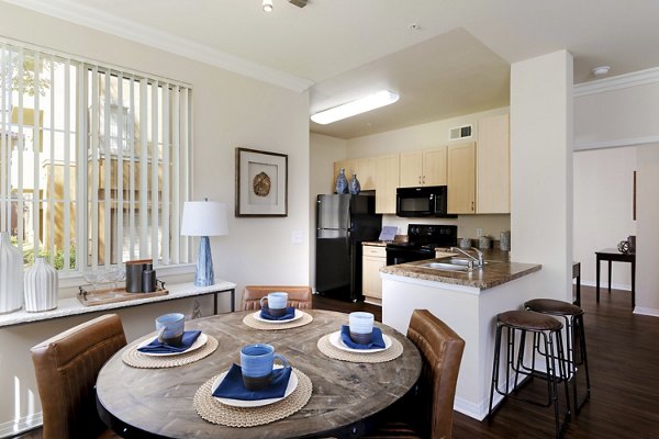 Modern dining area with stylish seating and large windows at Missions at Sunbow Apartments, luxury living in a vibrant community