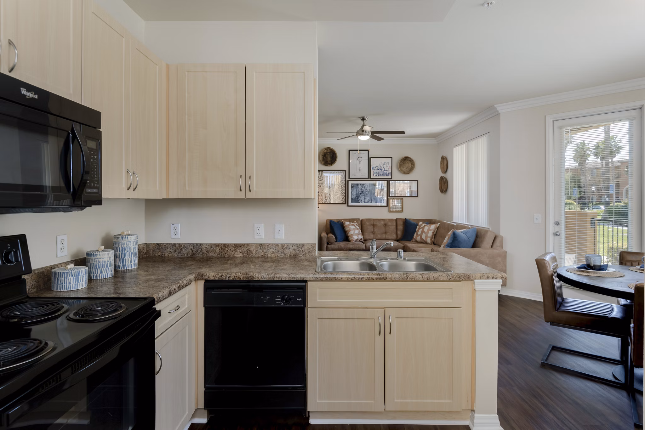 Modern kitchen with stainless steel appliances and granite countertops at Missions at Sunbow Apartments