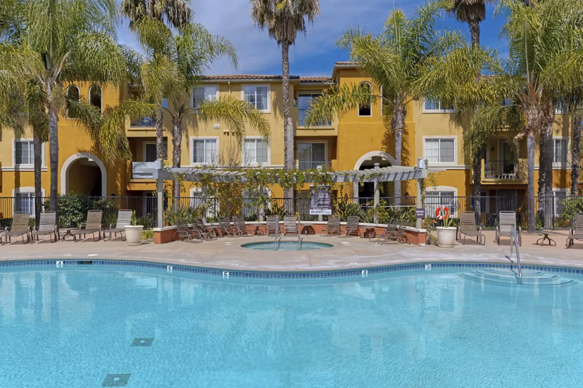 Resort-style pool with lush landscaping at Missions at Sunbow Apartments, perfect for relaxation and leisure activities