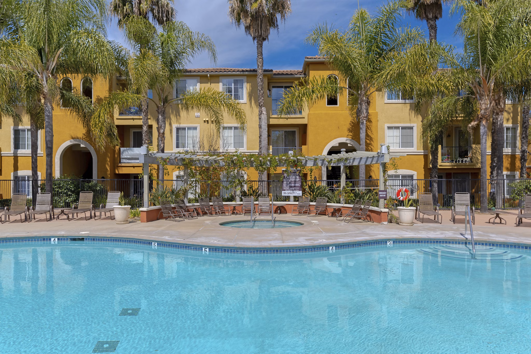 Resort-style pool with lush landscaping at Missions at Sunbow Apartments, perfect for relaxation and leisure activities