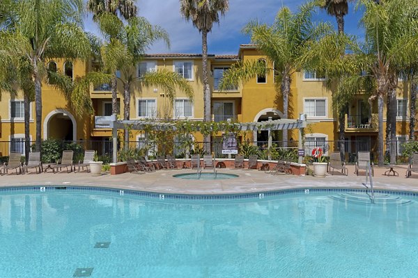 Resort-style pool with lush landscaping at Missions at Sunbow Apartments, perfect for relaxation and leisure activities