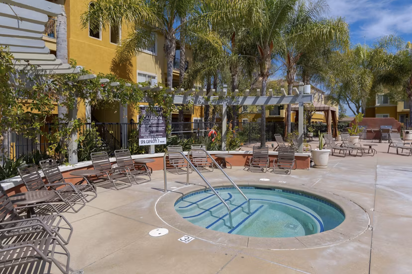 Relaxing hot tub at Missions at Sunbow Apartments with serene ambiance, perfect for unwinding after a long day