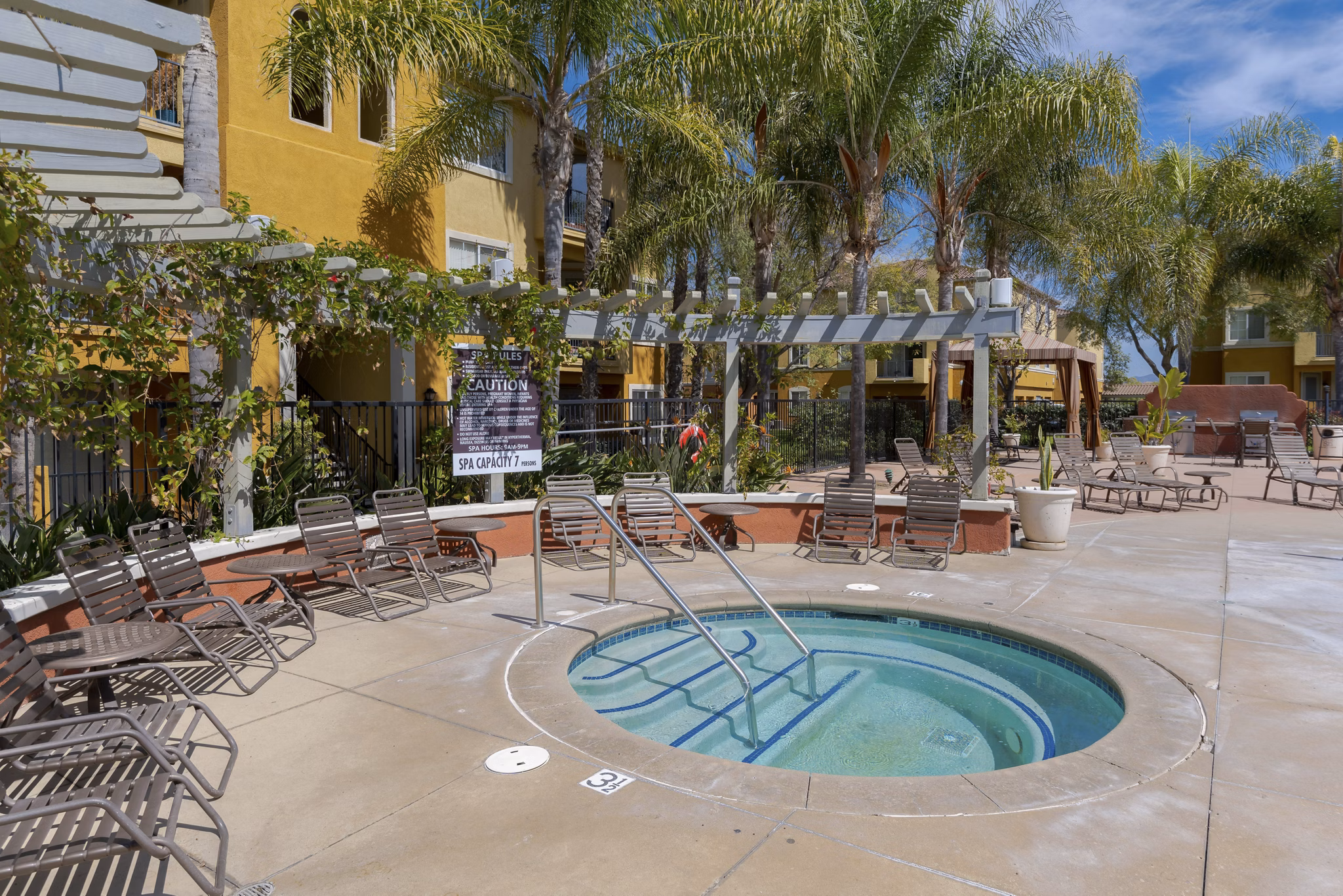 Relaxing hot tub at Missions at Sunbow Apartments with serene ambiance, perfect for unwinding after a long day