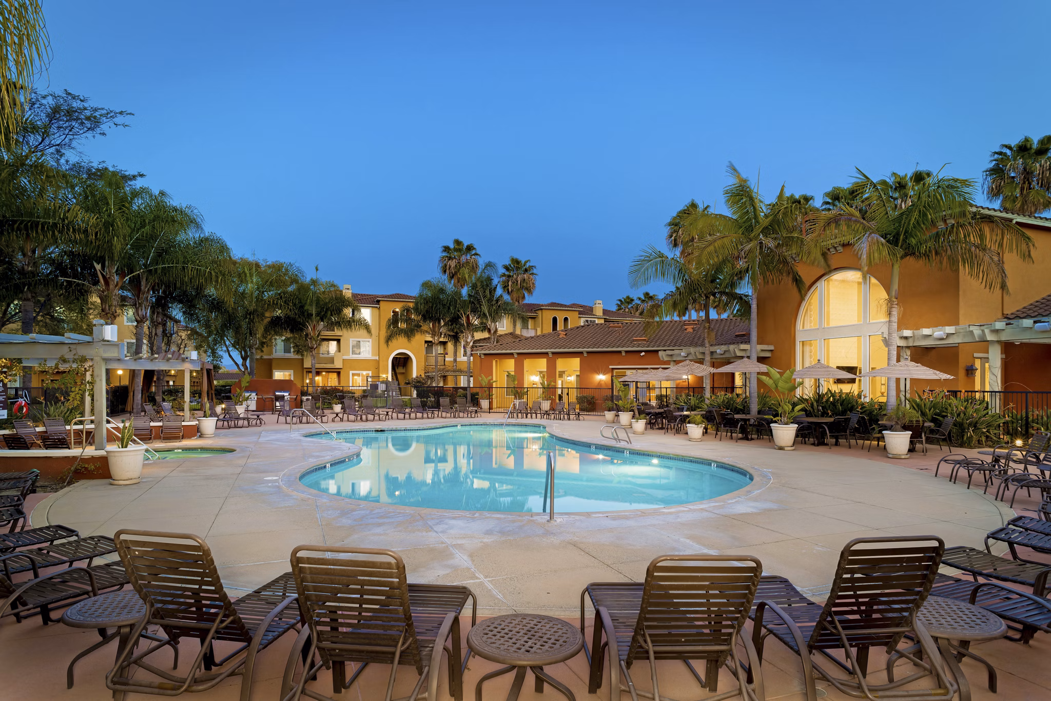 Resort-style pool with lounge chairs at Missions at Sunbow Apartments, ideal for relaxation and leisure activities