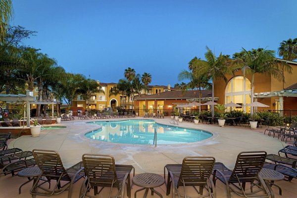Resort-style pool with lounge chairs at Missions at Sunbow Apartments, ideal for relaxation and leisure activities