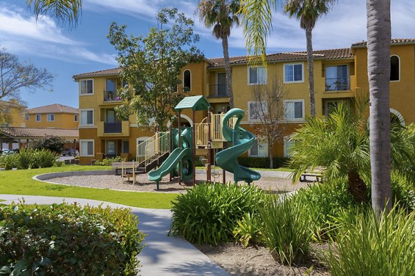 Playground at Missions at Sunbow Apartments featuring colorful slides and swings in Chula Vista Perfect for family-friendly outdoor fun