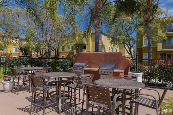 Outdoor grill area with seating at Missions at Sunbow Apartments