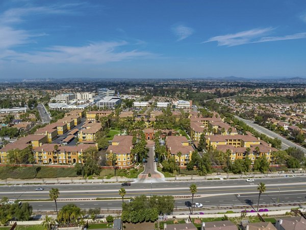 Missions at Sunbow Apartments: Scenic view of luxury apartment complex surrounded by lush greenery in Chula Vista, California