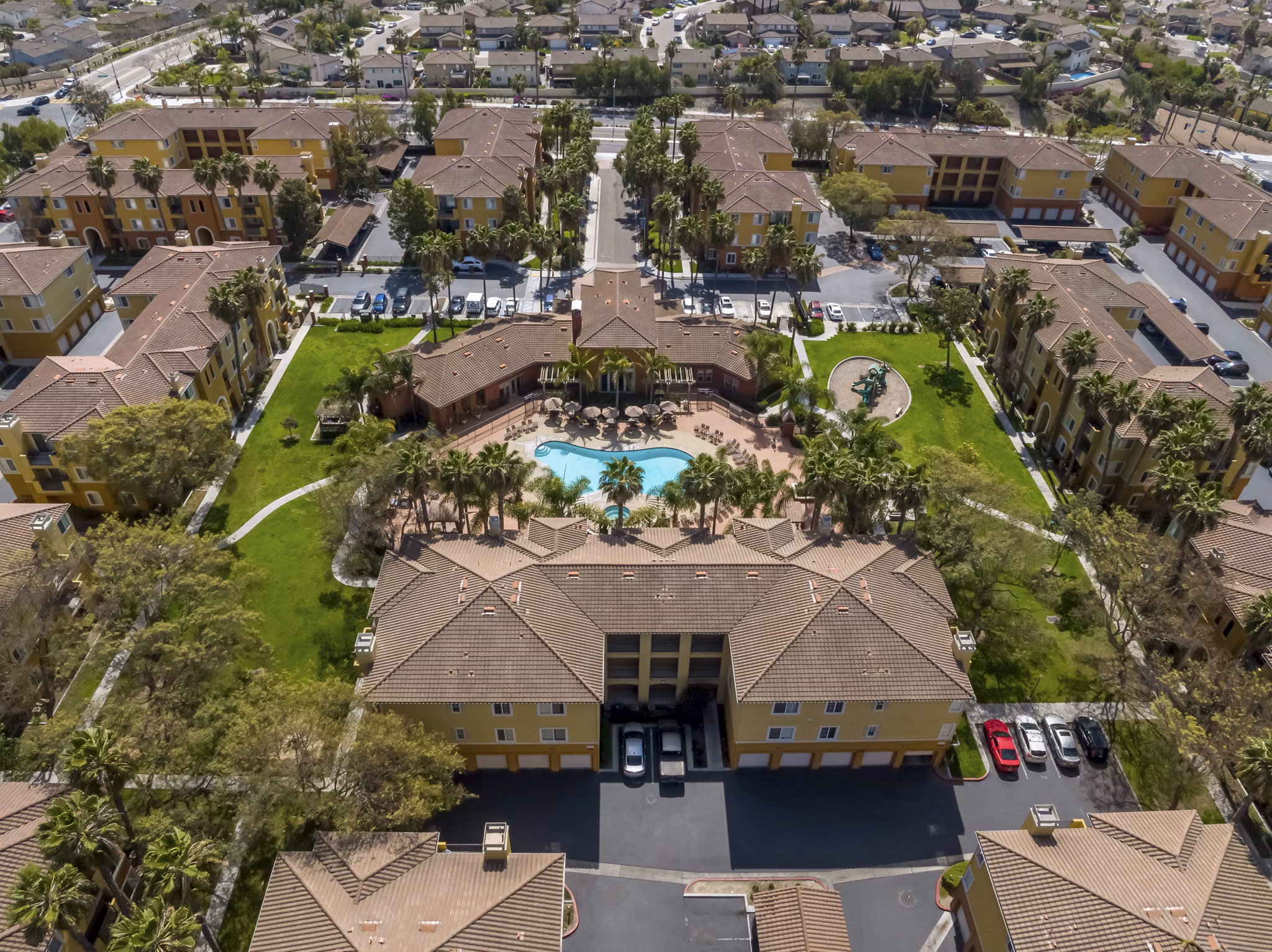 Missions at Sunbow Apartments: Scenic view of luxury apartment in Chula Vista, surrounded by lush landscaping